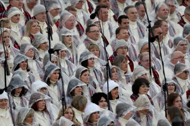 Members of the Mormon Tabernacle Choir sit on the West Front of the US Capitol