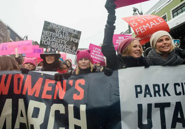 Chelsea Handler (C) and Charlize Theron (R) at the Women"s March in Park City, Utah