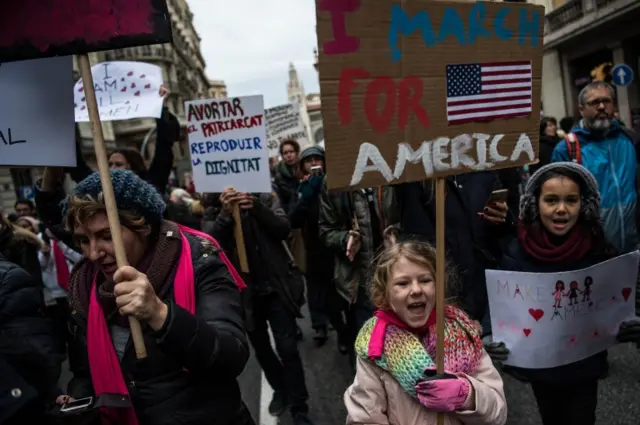 Demonstrators make their way during the Women"s March on January 21, 2017 in Barcelona, Spain. The Women"s March originated in Washington DC