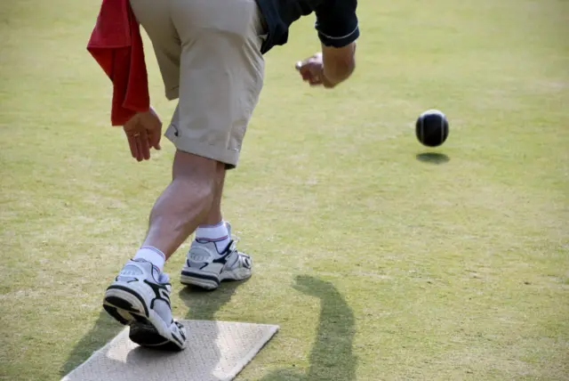 Man bowling on a outdoor green