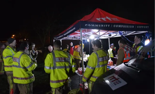 Night scene - fire crews at RRT stall