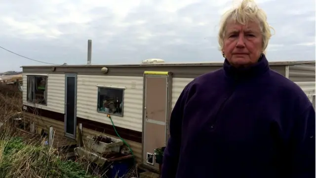 Bryony standing outside her mobile home