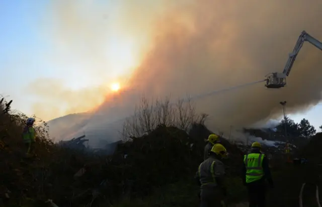 Firefighters and burning timber