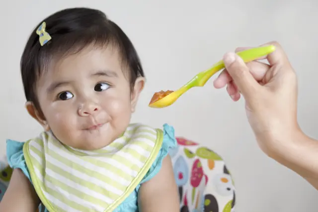 Baby being fed