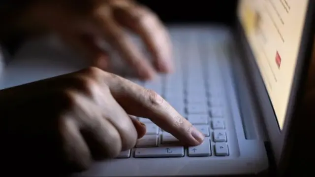 Person typing on computer