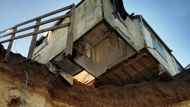 The Happisburgh home, balanced on cliff edge, after storm surge of 2013