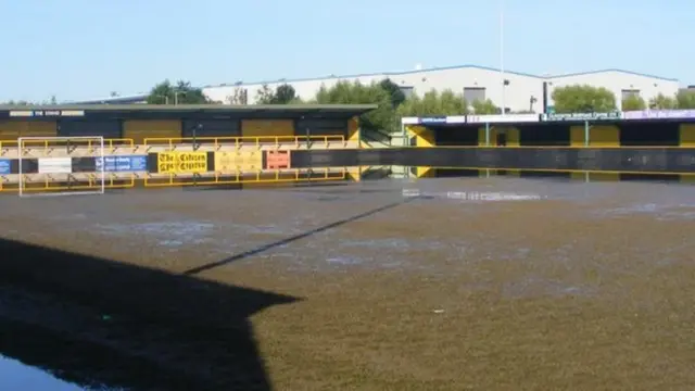 a football pitch covered in water and mud