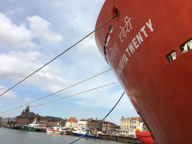 Close-up of the front of the Malaviya Twenty, with Great Yarmouth in the background