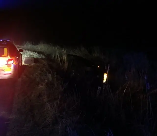 Car on its side in ditch at South Milford