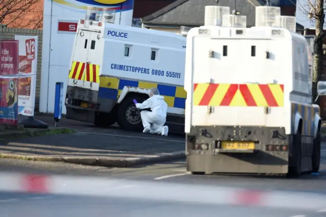 Police officers at the site of Sunday's shooting on the Crumlin Road