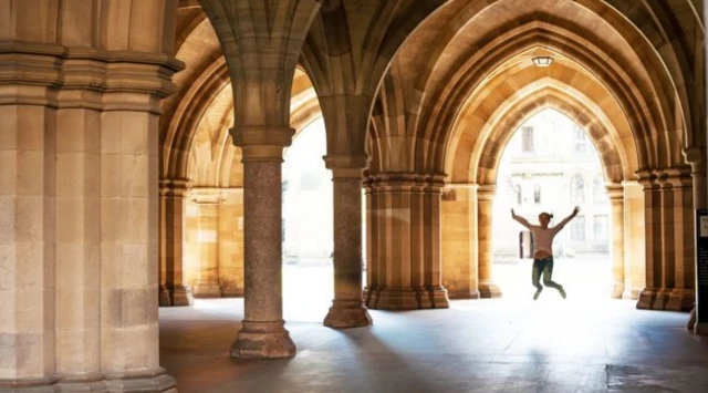 Student jumping in university campus