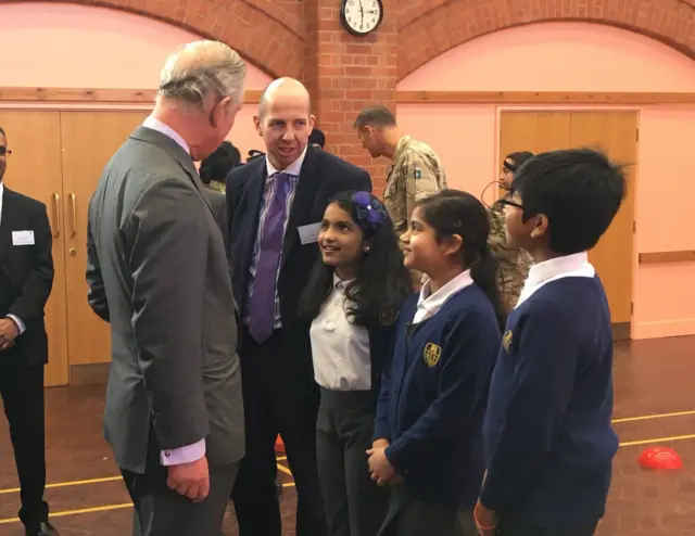 Prince Charles talking to school pupils