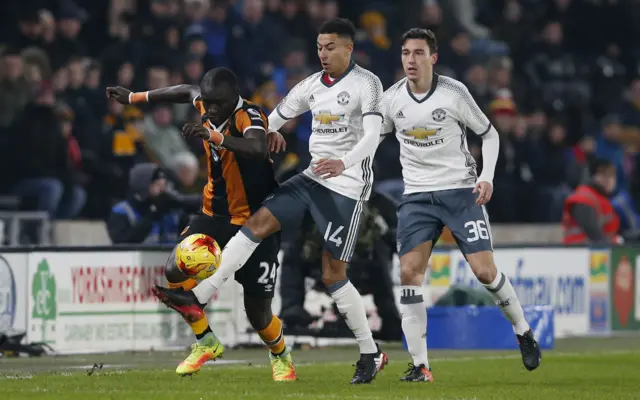 Hull City's Oumar Niasse in action with Manchester United's Jesse Lingard and Matteo Darmian