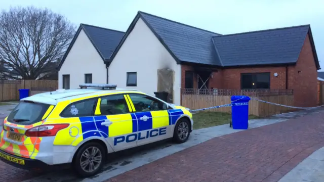 Police car outside bungalow