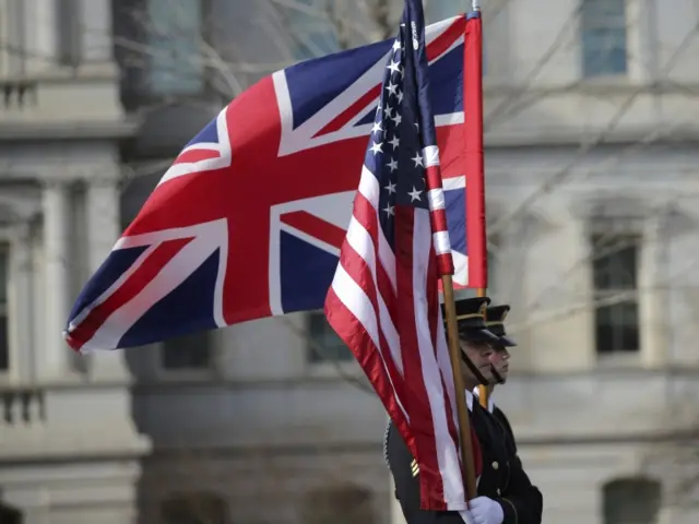 Honor guard members carry flags prior to arrival of British Prime Minister May at the White House in Washington