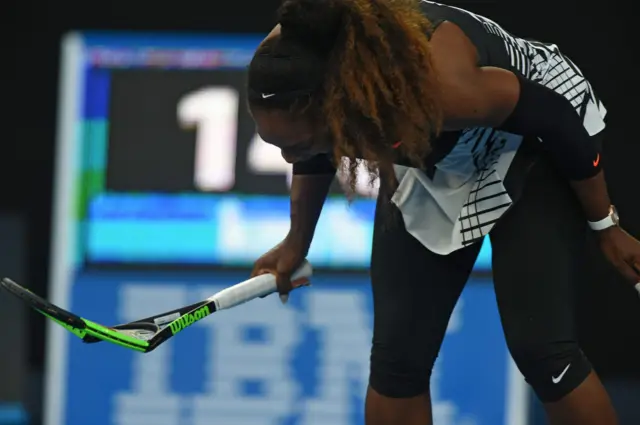 Serena Williams smashes her racket