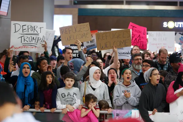 Protesters gather to denounce President Trump's executive order at Dallas-Fort Worth International Airport