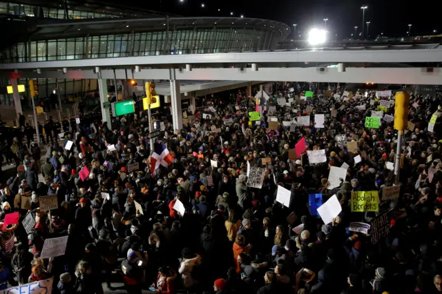 A protest against outside Terminal 4 at John F Kennedy International Airport in Queens, New York