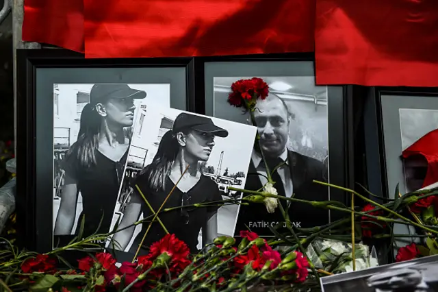 Pictures of victims of the New Year's Day attack on an Istanbul nightclub lie on Turkish national flags and flowers in front of the Reina nightclub on January 3, 2017 in Istanbul.