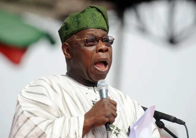 Olusegun Obasanjo speaking at a podium.