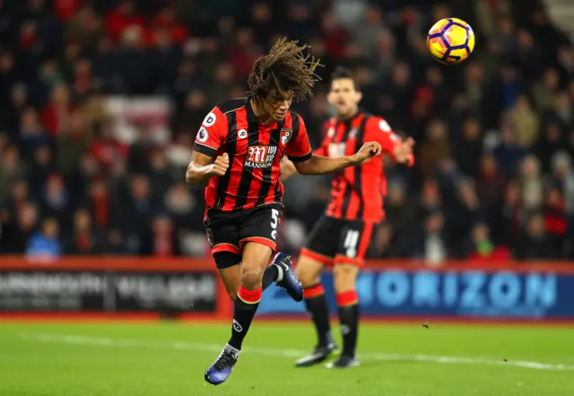 Nathan Ake heads the ball