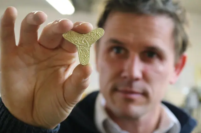 Artist Luke Jerram with a gold triform