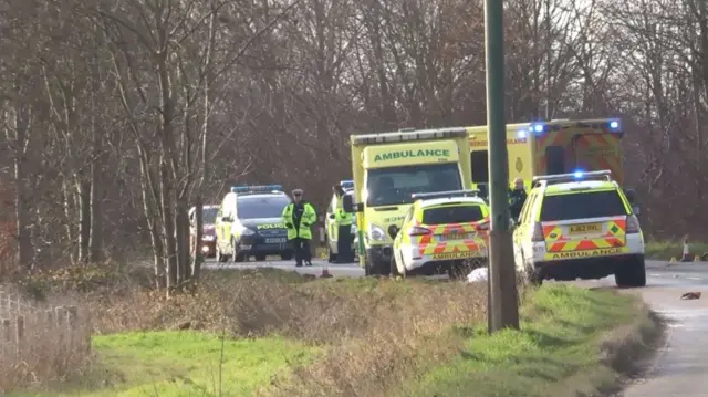 Police cars and ambulances at the scene