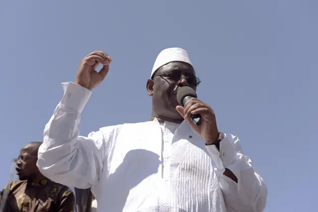 Senegal's President Macky Sall delivers a speech from a car's roof during a rally in Thies on March 16, 2016 on the last days of the the political campaign on constitutional reforms including the reduction of the presidential mandate, a referenda looking more like a vote in favour or not of President Macky Sall