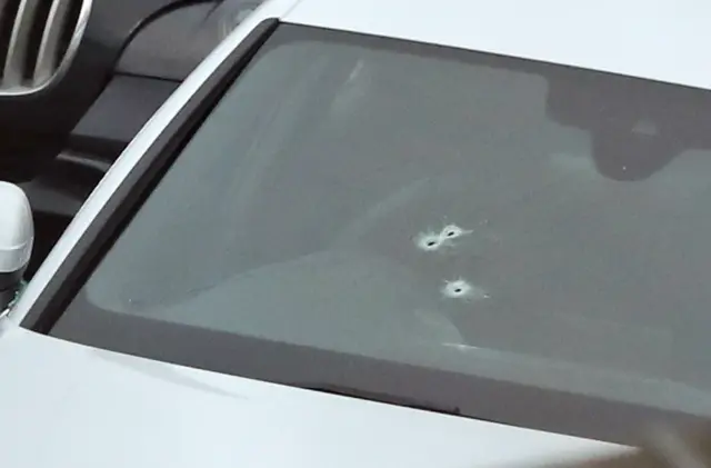 Bullet holes in the windscreen