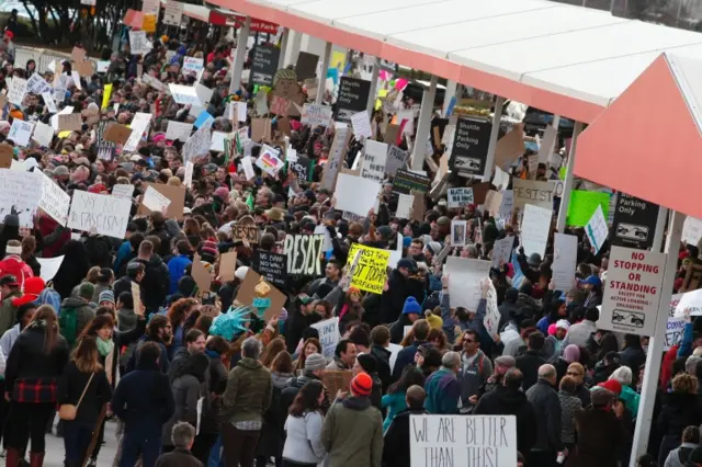 A large protest crowd is seen on the pedestrian paths in Atlanta