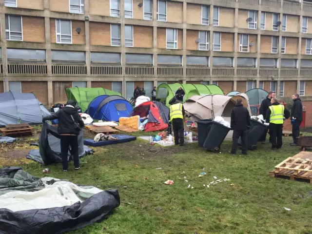 Council official take down tents and clear site