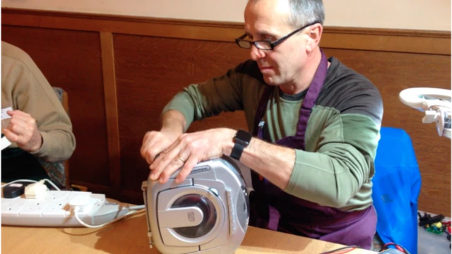 Roman Iwanczuk repairing a cd player