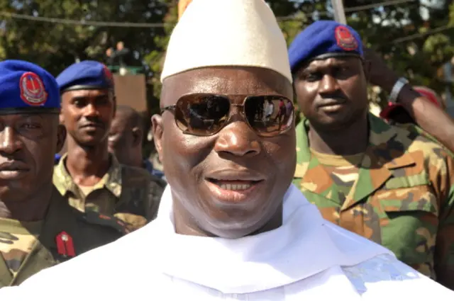 Gambian incumbent Yahya Jammeh speaks to journalists on November 24, 2011 as he leaves a polling station in the capital Banju