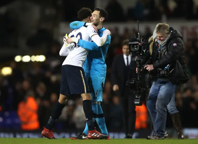 Dele Alli of Tottenham Hotspur and Hugo Lloris embrace