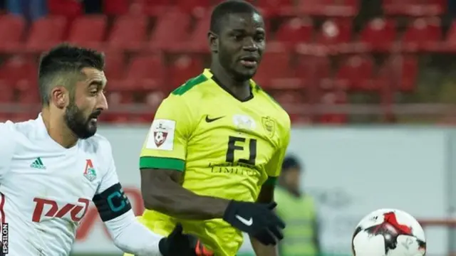 Jonathan Mensah and another footballer playing on a pitch