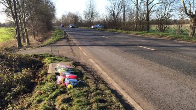 Flower tributes at the side of the road