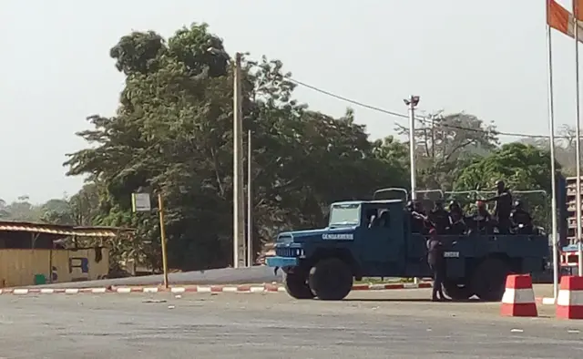 Ivorian gendarmes stand aboard a vehicle in a street of Bouake on January 6, 2017.