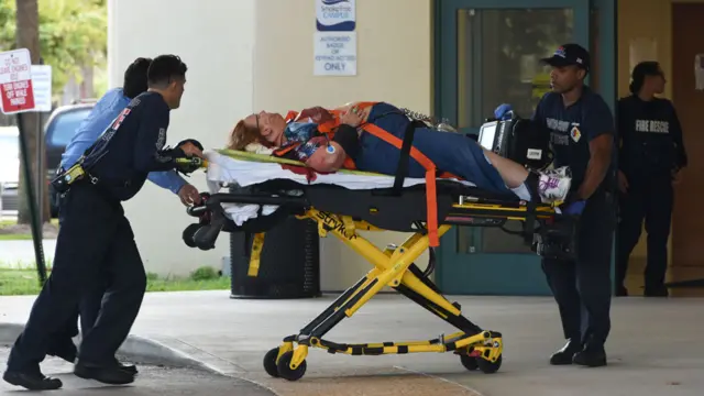 A shooting victim is unloaded from an emergency vehicle and taken into Broward Health Trauma Center in Fort Lauderdale, Florida