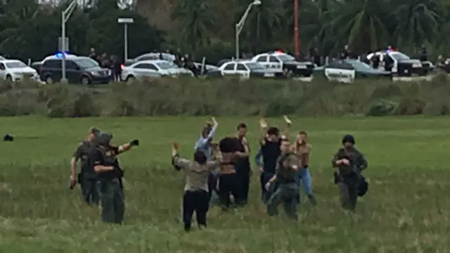 Police question people who are evacuating from Fort Lauderdale-Hollywood International Airport