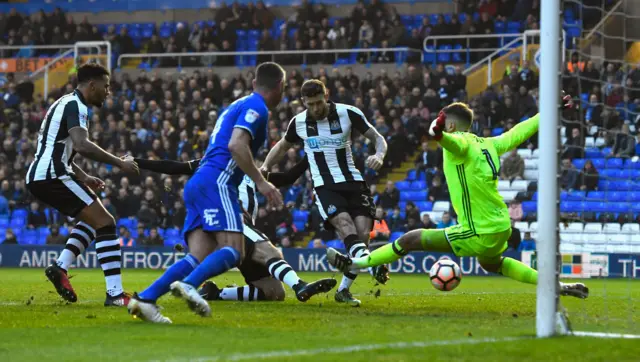 Newcastle player Daryl Murphy scores the opening goal