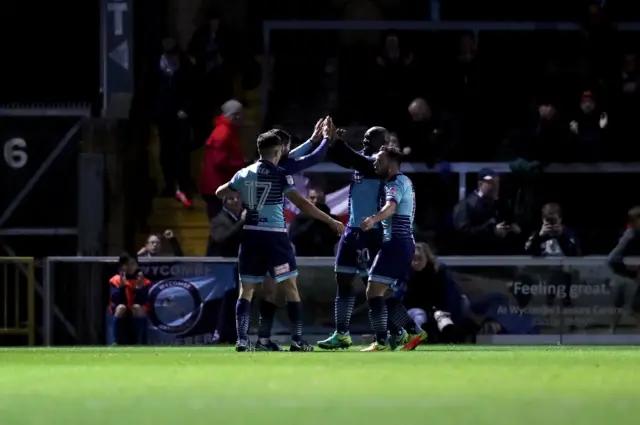 Adebayo Akinfenwa celebrates with his teammates