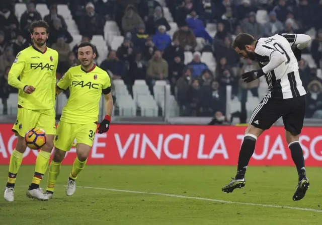 Gonzalo Higuain scores with a header