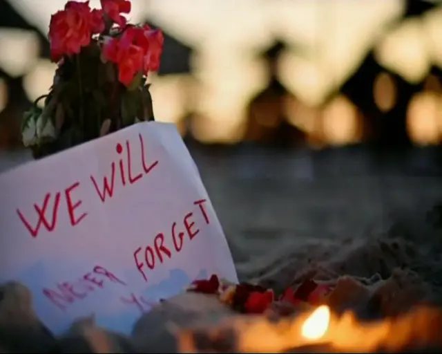 Photograph of candles and flowers on Tunisian beach