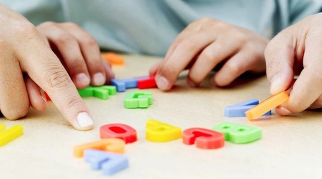 Pupil arranging coloured magnetic letters