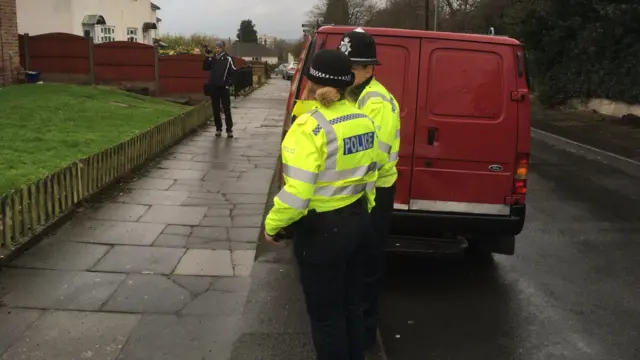 the van suspected of being used for flytipping, two police officers and a cameraman