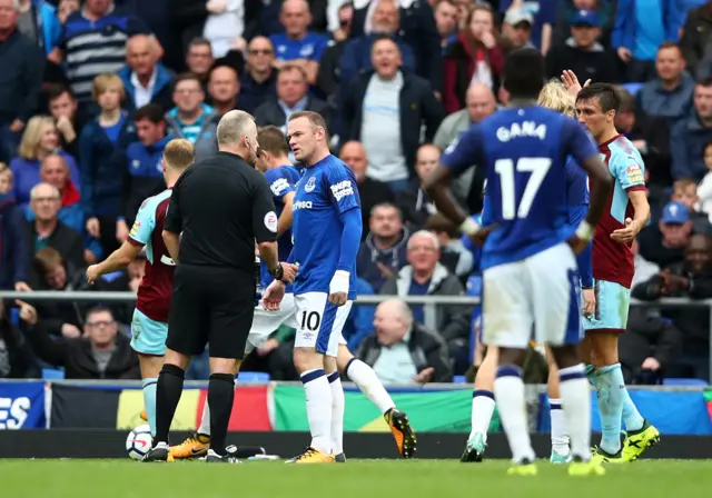 Rooney argues with the referee