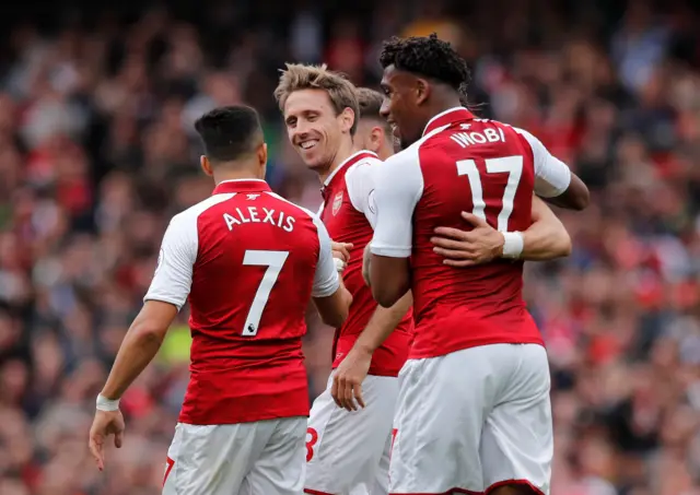 Arsenal players celebrate first goal