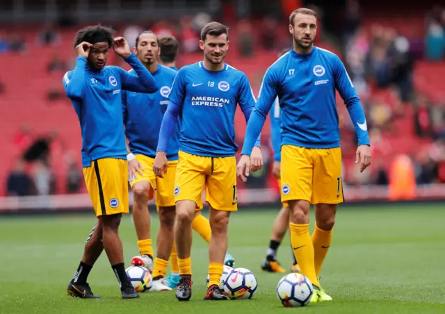 The Brighton players warm up