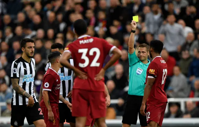 Liverpool's Gomez receives a yellow