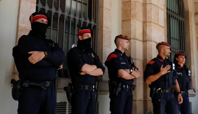 Catalan regional police officers stand guard outside the Catalonian regional parliament in Barcelona, Spain, 10 October 2017